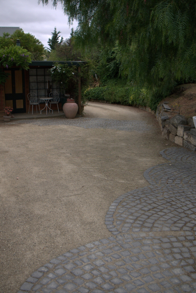 stone set in a curving pattern in gravel makes a beautiful pathway