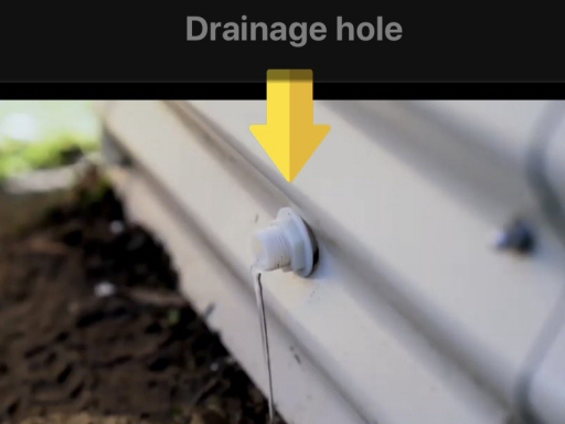 Drainage hole in a wicking bed